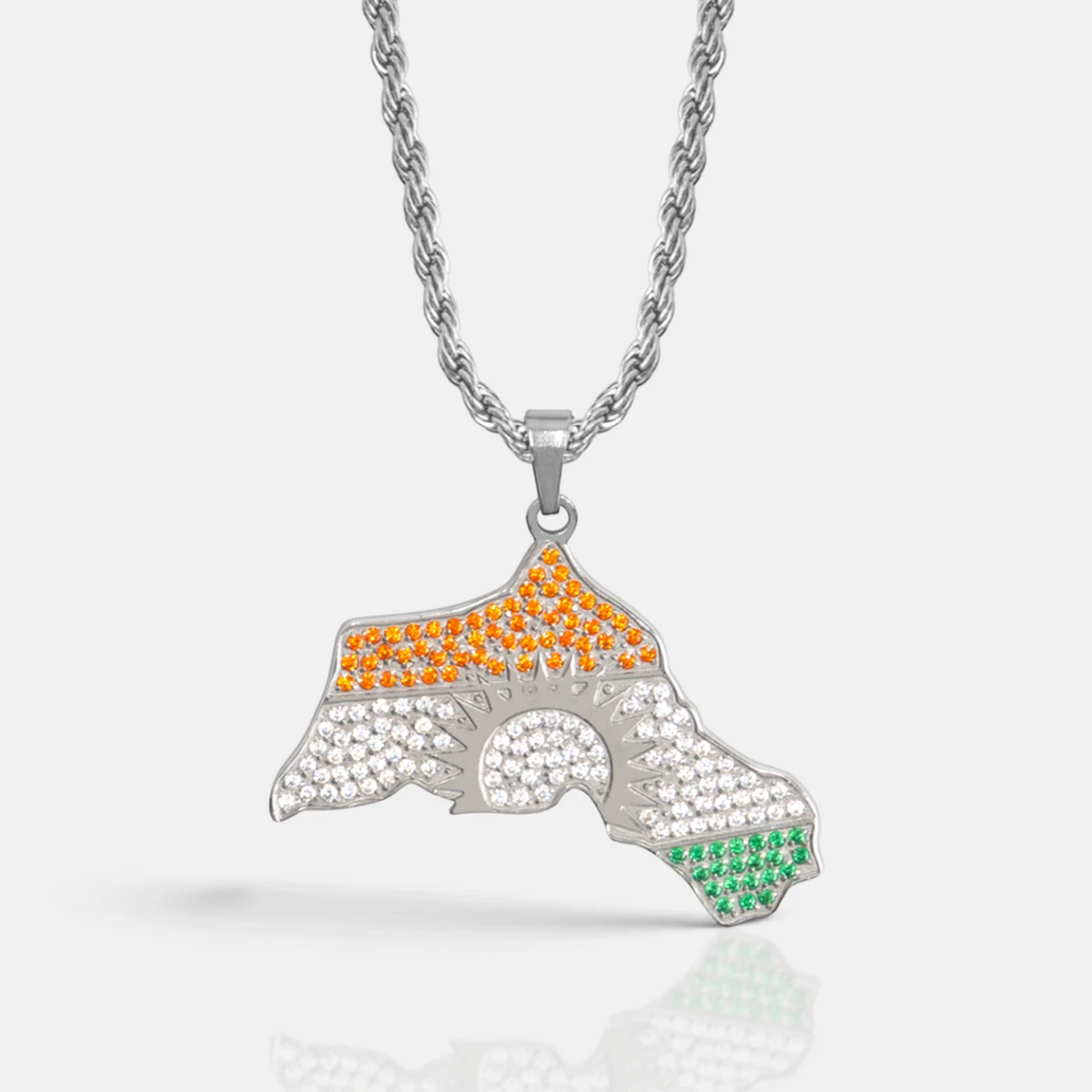 Kurdistan necklace for men in silver, map of Kurdistan pendant with red, white and green zirconia around the sun, rope chain, close-up of the pendant on grey with reflection