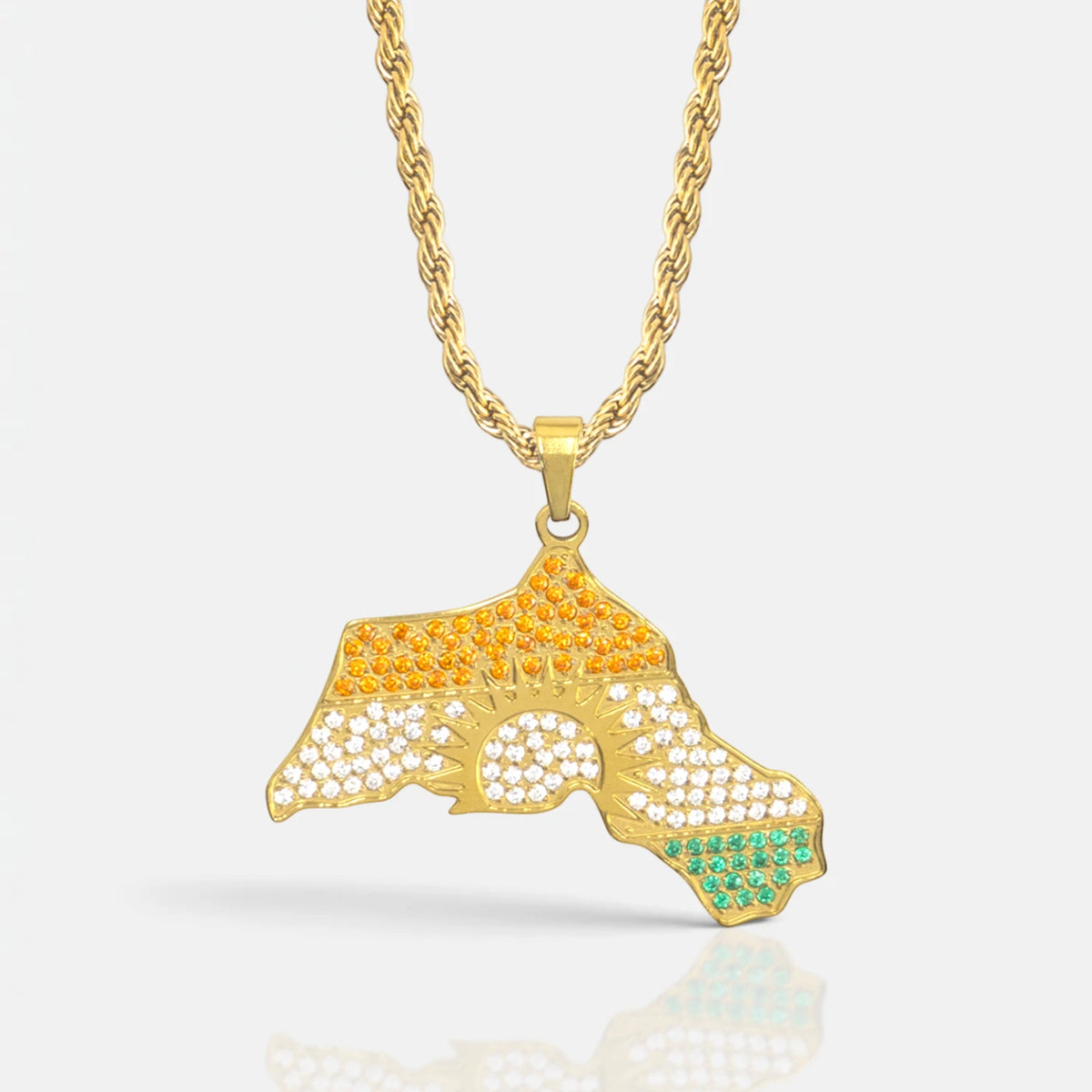 Kurdistan necklace for men in 18K gold, map of Kurdistan pendant with red, white and green zirconia around the sun, rope chain, close-up of the pendant on grey with reflection