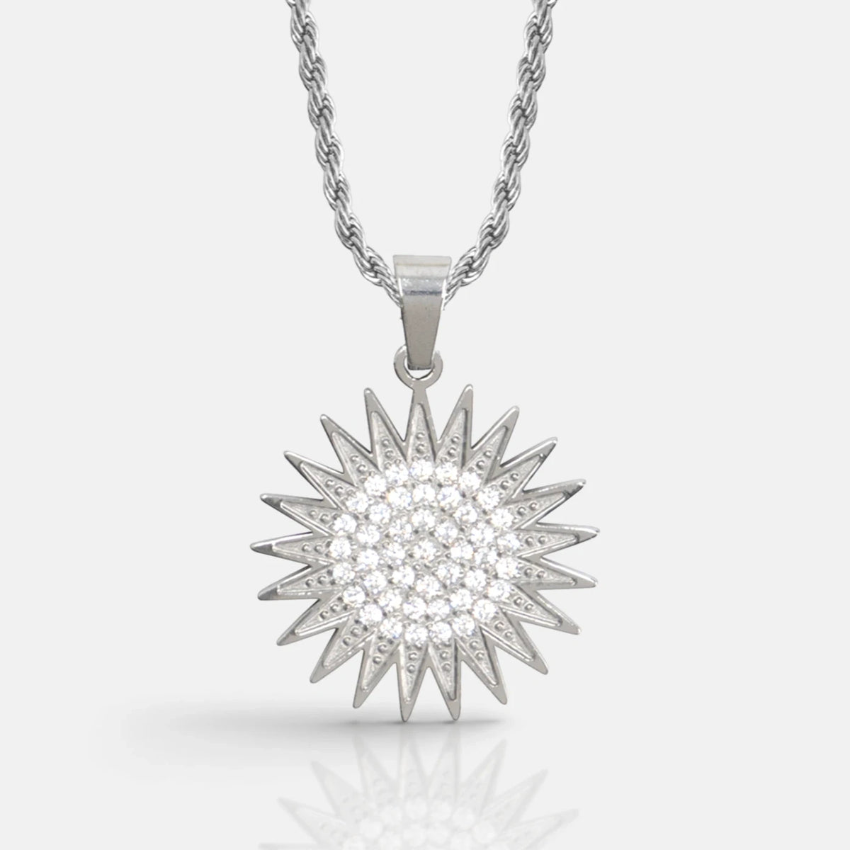 Kurdistan necklace Warrior for men in silver, Kurdish sun pendant with 21 rays and clear zirconia, rope chain, close-up of the pendant on grey with reflection